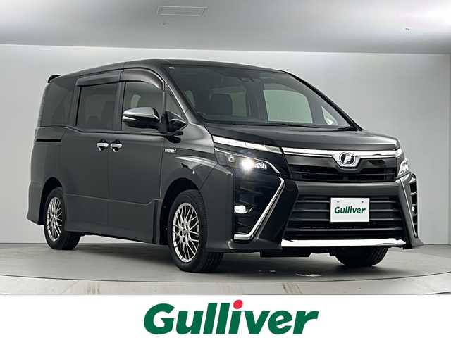 トヨタ ヴォクシー ハイブリッド ZS 煌 愛知県 2018(平30)年 5.8万km イナズマスパーキングブラックガラスフレーク 純正9インチSDナビゲーション/CD DVD フルセグTV Bluetooth/バックカメラ/ビルトインETC/トヨタセーフティセンス/レーンデパーチャーアラート/オートマチックハイビーム/純正フリップダウンモニター/両側パワースライドドア/クルーズコントロール/LEDヘッドライト/オートライト/フォグライト/シートヒーター(D/N)/横滑り防止装置/純正16インチアルミホイール/ウィンカーミラー/電動格納ミラー/スマートキー/エンジンプッシュスタート/ドアバイザー/フロアマット