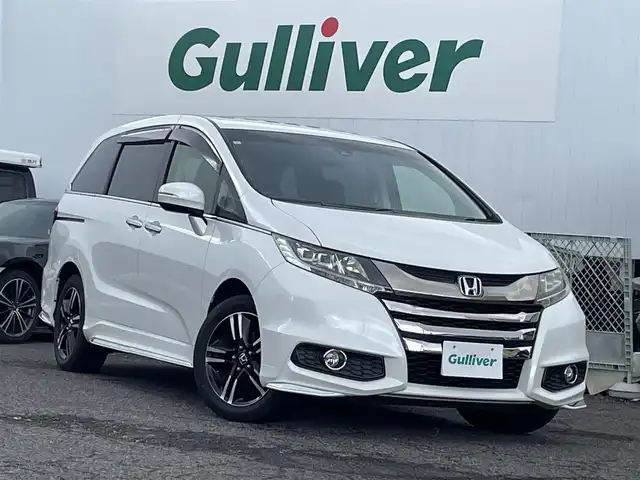 ホンダ オデッセイ アブソルート 福島県 2015(平27)年 8.7万km ホワイトオーキッドパール ４ＷＤ/純正ナビ/フルセグＴＶ/ＣＤ/ＤＶＤ/ＦＭ・ＡＭ/Ｂｌｕｅｔｏｏｔｈ/バックカメラ/片側パワスラ/レーンアシスト/衝突軽減ブレーキ/クルーズコントロール/社外センターコンソール/ＥＴＣ/純正フロアマット/ハーフレザーシート