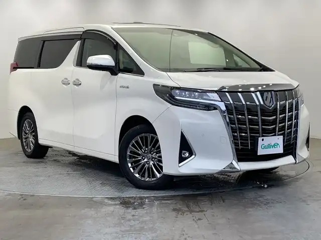トヨタ アルファードハイブリット エグゼクティブ ラウンジ 栃木県 2018(平30)年 3.7万km ラグジュアリーホワイトパールクリスタルシャインガラスフレーク 4WD/純正ナビ/（CD/DVD/フルセグTV/Bluetooth/USB）/バックカメラ/サイドカメラ/JBLプレミアムサウンドシステム/リアエンターテイメント/サンルーフ/トヨタセーフティセンス/・プリクラッシュセーフティ/・レーントレーシングアシスト/・レーンディパーチャーアラート/・ロードサインアシスト/・レーダークルーズコントロール/・オートマチックハイビーム/・先行車発進アラーム/・プロアクティブドライビングアシスト/・レーンチェンジアシスト/・緊急時操舵支援/コーナーセンサー/ETC2.0/両側パワースライドドア/パワーバックドア/前席パワーシート/前席シートヒーター/前席シートベンチレーション/禁煙車/LEDヘッドライト/AC100V電源/純正AW/純正フロアマット