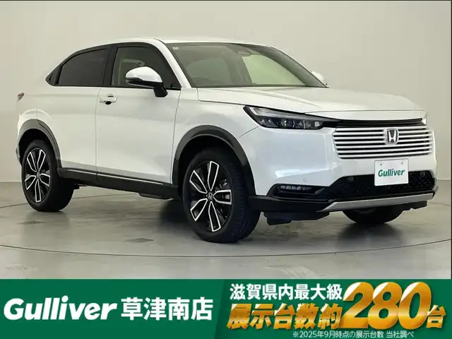 ホンダ ヴェゼル ハイブリッド e:HEV Z 滋賀県 2024(令6)年 1.6万km プラチナホワイトパール 純正9インチメモリナビ/【Bluetooth/USB/Apple Car Play/Android Auto/フルセグ 】/バックカメラ/ハーフレザー/シートヒーター/追従クルーズコントロール/前後ソナー/ホンダセンシング/パワーリアゲート/オートハイビーム/ステアリングヒーター/レーンキープアシスト/オートホールド/LEDヘッドライト/ビルトインETC2.0/純正18アルミ