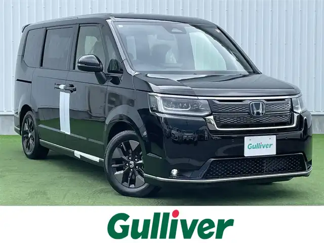 ホンダ ステップワゴン スパーダ eHEV 香川県 2025(令7)年 0.1千km クリスタルブラックパール 登録時走行距離：６ｋｍ/登録済未使用車/ホンダセンシング　/純正ナビゲーション/→フルセグ　/→ＣＤ／ＤＶＤ　/レーダークルーズコントロール/ブラインドスポットモニター/ステアリングリモコン/革巻きステアリング　　/シートヒーター　/両側パワースライド　/フリップダウンモニター　/オットマン　/ＬＥＤオートライト　/フォグランプ/前後コーナーセンサー/スマートキー/スペアキー