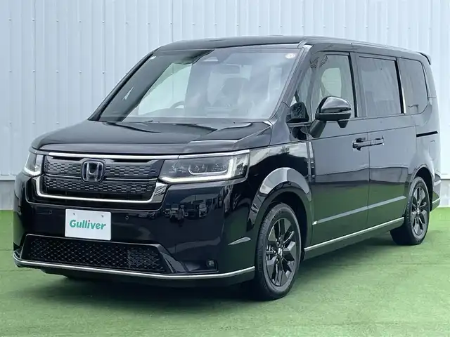 ホンダ ステップワゴン スパーダ eHEV 香川県 2025(令7)年 0.1千km クリスタルブラックパール 登録時走行距離：６ｋｍ/登録済未使用車/ホンダセンシング　/純正ナビゲーション/→フルセグ　/→ＣＤ／ＤＶＤ　/レーダークルーズコントロール/ブラインドスポットモニター/ステアリングリモコン/革巻きステアリング　　/シートヒーター　/両側パワースライド　/フリップダウンモニター　/オットマン　/ＬＥＤオートライト　/フォグランプ/前後コーナーセンサー/スマートキー/スペアキー