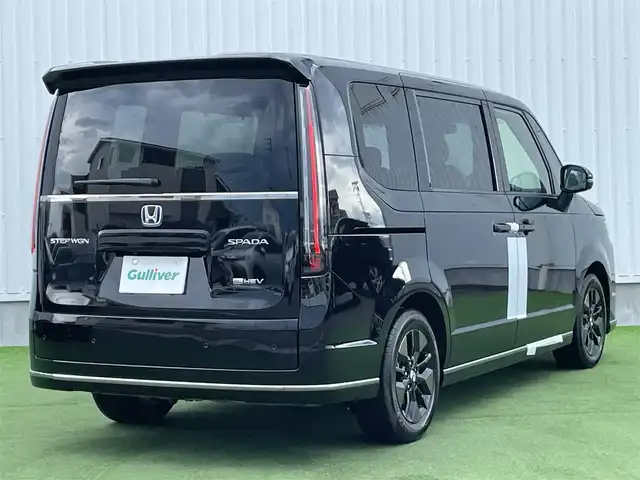 ホンダ ステップワゴン スパーダ eHEV 香川県 2025(令7)年 0.1千km クリスタルブラックパール 登録時走行距離：６ｋｍ/登録済未使用車/ホンダセンシング　/純正ナビゲーション/→フルセグ　/→ＣＤ／ＤＶＤ　/レーダークルーズコントロール/ブラインドスポットモニター/ステアリングリモコン/革巻きステアリング　　/シートヒーター　/両側パワースライド　/フリップダウンモニター　/オットマン　/ＬＥＤオートライト　/フォグランプ/前後コーナーセンサー/スマートキー/スペアキー