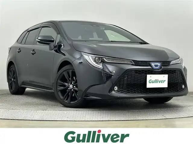 トヨタ カローラツーリング ハイブリッド W×B 50ミリオンED 道央・札幌 2022(令4)年 0.9万km ブラックマイカ ・4WD/・純正ナビ/　BT/USB/・純正ETC/・社外前後ドライブレコーダー/・バックカメラ/・衝突軽減ブレーキ/・レーダークルーズコントロール/・レーンキープアシスト/・横滑り防止/・ブラインドスポットモニター/・アイドリングストップ/・純正フロアマット/・ハーフレザー/・純正17インチAW/・LEDヘッドライト/・オートライト/・プッシュスタート/・スマートキー×2/・取扱説明書