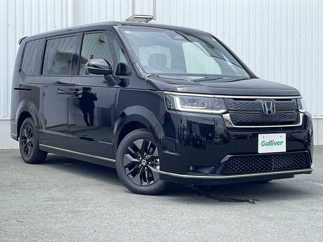 ホンダ ステップワゴン スパーダ eHEV 三重県 2025(令7)年 0.1千km クリスタルブラックパール 登録済未使用車/純正11.4型ナビ(AM/FM/CD/DVD/TV/BT)/純正15.6型リア席モニター/バックカメラ/BSM/前席シートヒーター/電動リヤゲート/スペアキー/オットマン/USB・タイプC給電ポート/革巻きステアリング/コーナーセンサー/レーダークルーズコントロール/パドルシフト/ウォークスルー/オートハイビーム/両側パワースライドドア/デイライト/電動格納ミラー/禁煙車