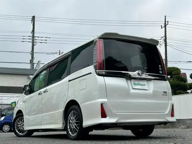 トヨタ ノア ハイブリッド Si ダブルバイビー 東京都 2018(平30)年 9.4万km ホワイトパールクリスタルシャイン ワンオーナー/純正SDナビ（NSZN-Z68T）/・Bluetoothオーディオ/フルセグTV/DVD/後席用モニター/ワンタッチスイッチ付両側パワースライドドア/リヤオートエアコン/シートヒーター（前席）/純正ビルトインETC2.0/Toyota Safety Sense/取扱説明書/保証書/スペアキー1本