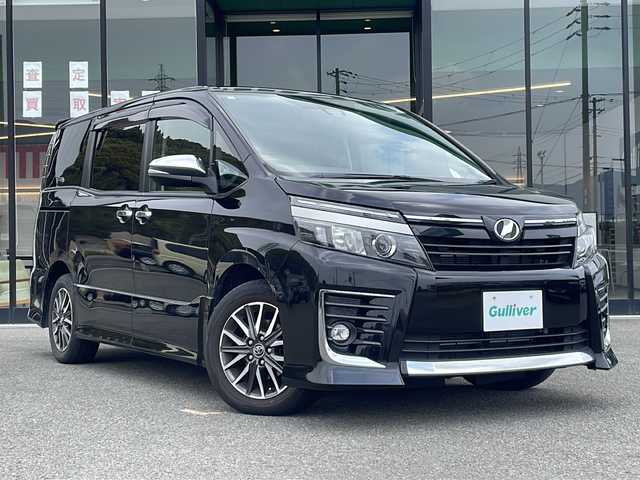 トヨタ ヴォクシー ZS 煌Ⅱ 兵庫県 2016(平28)年 7.9万km ブラック 純正10インチSDナビ/両側パワースライドドア/アイドリングストップ/革巻きステアリング/12.8インチフリップダウン/禁煙車/セーフティセンスC/プリクラッシュセーフティ/レーンディパーチャーアラート/オートマチックハイビーム/LEDオートライト/レザー調シートカバー
