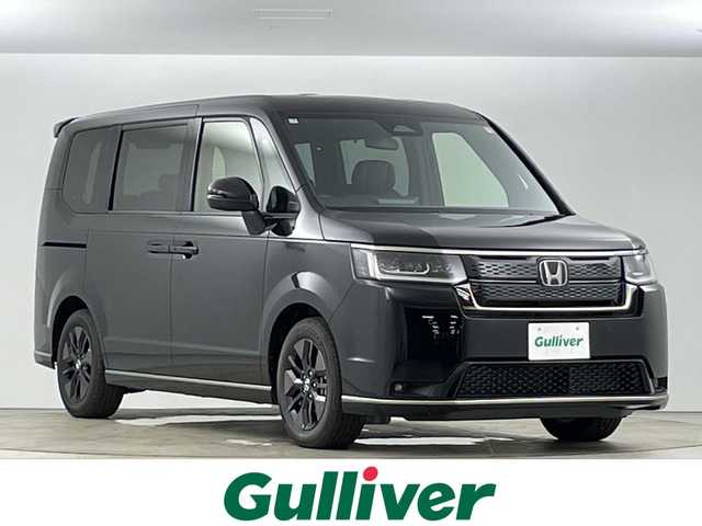 ホンダ ステップワゴン スパーダ eHEV 愛知県 2025(令7)年 0.1万km未満 クリスタルブラックパール 登録済未使用車/純正11.4インチナビ/（CD/DVD/フルセグTV/Bluetooth/SD)/フリップダウンモニター/バックカメラ/ホンダセンシング/・衝突軽減ブレーキ/・レーンキープアシスト/・追従式クルーズコントロール/・オートマチックハイビーム/・ブラインドスポットモニター/・クリアランスソナー/シートヒーター/オットマン/パワーバックドア/両側パワースライドドア/純正16インチアルミホイール/スマートキー/スペアキー有/横滑り防止装置/LEDヘッドライト/フロントフォグライト
