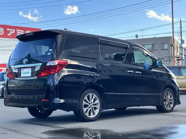 トヨタ アルファード 240S プライムセレクションⅡ 静岡県 2010(平22)年 9.5万km ブラック エンジンスタートボタン/パワーステアリング/パワーウィンドウ/スマートキー/Wオートエアコン/ALPINE製後席モニター/ETC/バックカメラ/SDナビ（CD/DVD/BT/フルセグ）/三列シート/オットマン/電動リアゲート/ウォークスルー/純正フロアマット/純正アルミホイール/両側パワースライドドア/布シート/ABS/横滑り防止装置/コーナーセンサー前後/オートライト/W+サイドエアバッグ/カーテンエアバッグ