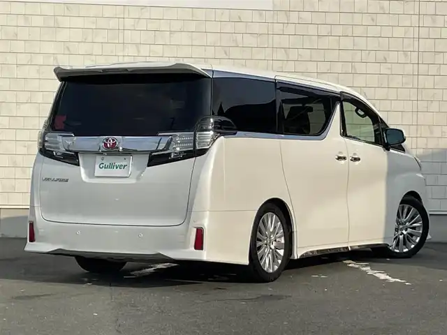 トヨタ ヴェルファイア Z Aエディション 愛知県 2015(平27)年 8.2万km ホワイトパールクリスタルシャイン TEIN車高調/モデリスタフロントグリル/ETC/USB/HDMI接続/クルーズコントロール/両側パワースライドドア/ツインムーンルーフ/純正フロアマット/ウォークスルー（2列目）/オットマン（N、2列目）/純正18インチアルミホイール/LEDヘッドライト/コーナーセンサー/横滑り防止装置/衝突軽減ブレーキ/MTモード付きAT/AC100V/全席オートエアコン/スマートキー/プッシュスタート