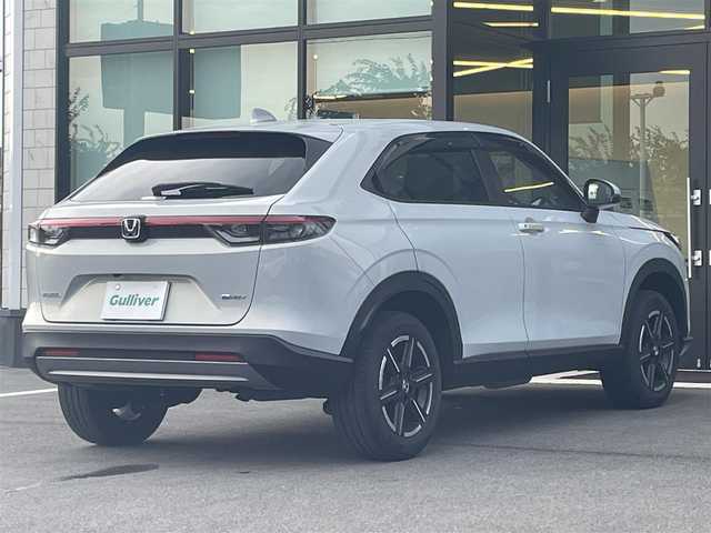 ホンダ ヴェゼル ハイブリッド e:HEV X 愛媛県 2022(令4)年 2.4万km プレミアムサンライトホワイトパール 純正ナビ（Bluetooth/HDD/フルセグテレビ）/追従クルーズコントロール/バックカメラ/前方ドライブレコーダー/パドルシフト/パーキングセンサー/ETC2.0/ABS/横滑り防止装置/前後コーナーセンサー/レーンキープアシスト/衝突被害軽減システム/ダウンヒルアシストコントロール/純正フロアマット/純正16インチアルミホイール/カーテンエアバック/置くだけ充電/USB入力端子/LEDヘッドライト/オートライト