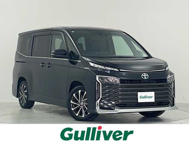 トヨタ ヴォクシー ハイブリッド S－Z 大阪府 2023(令5)年 2.4万km グリッターブラックガラスフレーク 禁煙車/トヨタセーフティセンス/　・プリクラッシュセーフティ　PCS/　・レーントレーシングアシスト　LTA/　・レーンディパーチャーアラート　LDA/　・レーダークルーズコントロール　ACC/　・ロードサインアシスト　RSA/　・フロントクロストラフィックアラート　FCTA/　・リアクロストラフィックアラート　RCTA/　・プロアクティブドライビングアシスト　PDA/　・パーキングサポートブレーキ　PSB/　・発信遅れ告知機能　TMN/純正ディスプレイオーディオ/　Bluetooth/フルセグ/CD/DVD/バックカメラ/両側パワースライドドア/ハーフレザーシート/前席シートヒーター/LEDオートライト/オートマチックハイビーム　AHB/フォグランプ/純正17インチアルミホイール/スマートキー/ETC2.0/フロアマット/ドアバイザー