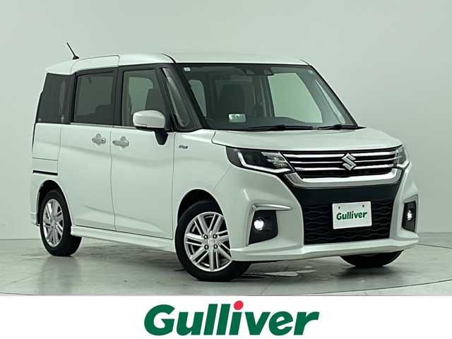 スズキ ソリオ HV MZ 大阪府 2023(令5)年 3.1万km ピュアホワイトP スズキセーフティサポート/　・衝突被害軽減ブレーキ/　・車線逸脱警報/　・道路標識認識機能/　・前後呉発進抑制機能/社外メモリナビ/　TV/FM/AM/Bluetooth/フルセグ/両側パワースライドドア/アダプティブクルーズコントロール/LEDヘッドライト(オートライト・フォグランプ)/シートヒーター（運転席・助手席）/純正１５インチアルミホイール/ヘッドアップディスプレイ/コーナーセンサー(後方)/アイドリングストップ/格納電動ウィンカーミラー/プッシュスタート/ETC/ドアバイザー/ビークルダイナミクスコントロール