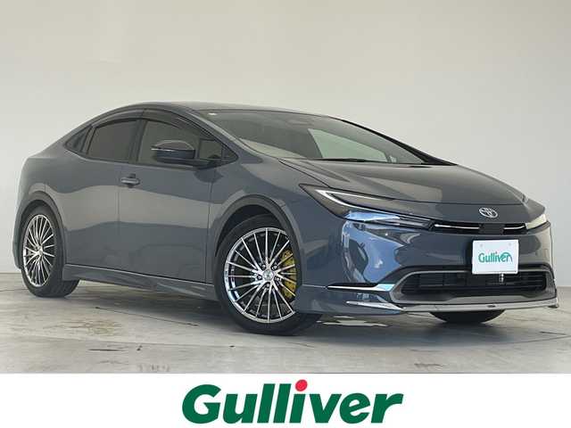 トヨタ プリウス G 愛知県 2024(令6)年 0.8万km グレー モデリスタエアロパーツ/純正７型ディスプレイオーディオ（ナビあり）/全方位カメラ/レーダークルーズコントロール/シートヒーター/バックカメラ/コーナーセンサー/アルミホイール/ブラインドスポットモニター/LEDヘッドライト/インテリジェントミラー/オートマチックハイビーム/ドライブレコーダー/ＥＴＣ２．０/衝突軽減システム/フルセグ/Bluetooth/ステアリングスイッチ/スマートキー/プッシュスタート/キャリパー