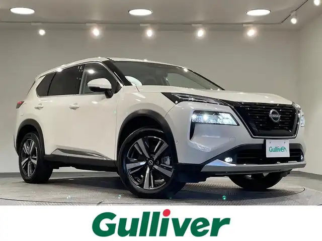 日産 エクストレイル G e－4ORCE 愛知県 2023(令5)年 3.4万km ブリリアントホワイトパール 純正１２．３インチナビ　/（AM/FM/フルセグTV/Bluetooth/USB/CarPlay)/アラウンドビューモニター　/プロパイロット　/自動駐車システム（プロパイロットパーキング）　/ＡＣ１００Ｖ　/ビルトインＥＴＣ２．０　/全席シートヒーター　/電動バックドア　/デジタルインナーミラー　/ワイヤレス充電　/ブラインドスポットモニター（ＢＳＭ）/ヘッドアップディスプレイ（HUD）/メモリ機能付パワーシート/クリアランスソナー/車線逸脱警報/LEDヘッドライト/LEDフォグランプ/黒レザーシート