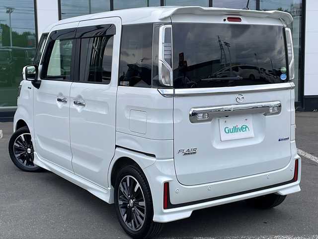 マツダ フレアワゴン カスタムスタイル ハイブリッド XS 道東・釧路十勝 2020(令2)年 4.8万km ピュアホワイトP ・４WD/・社外SDメモリナビ/（CD・DVD・AM・FM・BT・フルセグ）/・バックカメラ/・両側パワースライドドア/・ETC/・前後ドライブレコーダー/・アイドリングストップ/・スマートキー/・プッシュスタート/・衝突被害軽減ブレーキ/・横滑り防止装置/・車線逸脱防止機能/・革巻きステアリング/・ハーフレザーシート/・前席シートヒーター/・オートライト/・ヒーテッドドアミラー/・LEDヘッドライト/・フォグライト/・純正フロアマット/・ドアバイザー