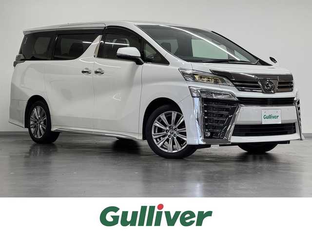 トヨタ ヴェルファイア Z ゴールデンアイズ 三重県 2020(令2)年 5万km ホワイトパールクリスタルシャイン ガソリン/FF/MTモード付インパネCVT/純正 9インチディスプレイオーディオ（ナビ搭載）/（AM/FM/TV/Bluetooth/USB/iPod/Miracast/AppleCarPlay/AndroidAuto）/純正12.1インチ後席モニター V12T-R68C/バックカメラ/両側パワースライドドア/ビルトイン ETC/Toyota Safety Sense/・プリクラッシュセーフティ/・レーントレーシングアシスト/・レーダークルコン（全車速追従機能付）/・インテリジェントクリアランスソナー（パーキングサポートブレーキ（静止物））/・【OP】ブラインドスポットモニター＆リヤクロストラフィックアラート/・アダプティブハイビームシステム/・ロードサインアシスト/・先行車発進告知機能/装備/・【OP】デジタルインナーミラー/・【OP】寒冷地仕様（リヤフォグランプ、ウインドシールドデアイサー、ワイパーモーター・オルタネータ容量＆エンジン冷却液濃度UP、補助ヒーターなど）/・ハーフレザーシート/・パワーバックドア/・2ndシートオットマン/・AC100Vコンセント（100W）/・左右＆後席独立オートエアコン/・3眼LEDヘッドランプ/・純正18inAW/・スマートキーx2、リモコンE/Gスターターx1/など