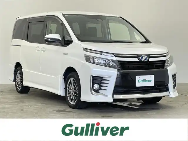トヨタ ヴォクシー ハイブリッド ZS 千葉県 2016(平28)年 6.5万km ホワイトパールクリスタルシャイン トヨタセーフティセンス/・プリクラッシュセーフティ/・レーンディパーチャーアラート/・先行車発進通知/・オートハイビーム/純正9インチSDナビ/CD BT MSV フルセグ/バックカメラ/両側パワースライドドア/LEDオートライト/純正16インチアルミホイール/ドアバイザー/純正フロアマット/革巻きステアリング/ビルトインETC