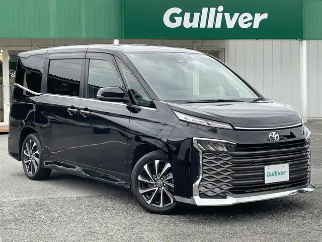トヨタ ヴォクシー S－Z 千葉県 2022(令4)年 3.9万km アティチュードブラックマイカ ワンオーナー/10.5インチディスプレイオーディオPlus/・10.5インチディスプレイオーディオ/・DVD/CD/フルセグTV/Bluetooth/・HDMI端子/・ETC2.0ユニット/・スピーカー12個/快適利便パッケージHigh/・ハンズフリーデュアルパワースライドドア/・パワーバックドア/・ナノイーX/ステアリングヒーター/・1列目2列目シートヒーター/・2列目オットマン/純正14インチフリップダウンモニター【V14T-R72R】/バックカメラ/ユニバーサルステップ/Toyota　Safety　Sense/・プリクラッシュセーフティシステム/・レーンディパーチャーアラート/・オートマチックハイビーム/・ロードサインアシスト/・レーダークルーズコントロール/・パーキングサポートブレーキ/ビルトインETC2.0/社外前後ドライブレコーダー/本革巻ステアリング/リア席サンシェード/スマートキー/プッシュスタート/純正LEDヘッドライト/前後コーナーセンサー/純正17インチアルミホイール/ブレーキオートホールド/純正フロアマット/ドアバイザー/サイド＆カーテンエアバッグ/新車時保証書＆取扱説明書
