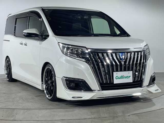 トヨタ エスクァイア ハイブリッド Gi 福岡県 2019(平31)年 3.7万km ホワイトパールクリスタルシャイン ALPINE11インチメモリナビ/・CD/DVD/BT/フルセグTV/・バックモニター/ALPINE12.8インチフリップダウンモニター/トヨタセーフティ/・プリクラッシュセーフティ/・レーンディパーチャーアラート/・先行車発進告知/・パーキングサポートブレーキ/クリアランスソナー/社外19インチアルミホイール/純正ダイナミックエアロ/TEIN車高調/両側パワースライドドア/革シート/・シートヒーター（D/N)/革巻きステアリング/・ステアリングリモコン/ドライブレコーダー前後/ETC/オートライト/・LEDヘッドライト/・フォグランプ