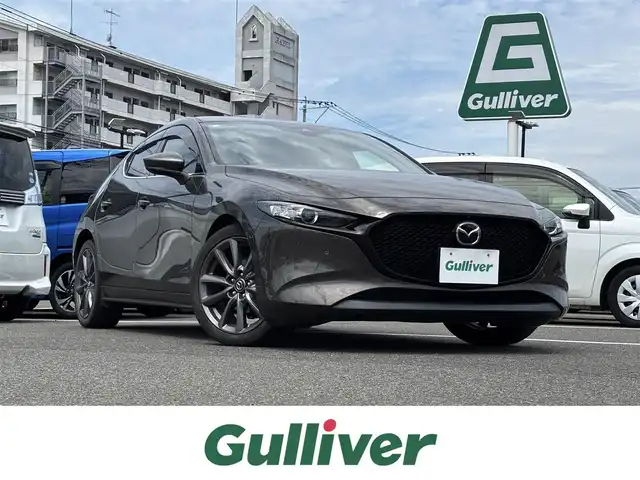 マツダ マツダ３ファストバック 15S ツーリング 大分県 2020(令2)年 5.4万km チタニウムフラッシュマイカ ・純正ナビ(CD/DVD/BT/SD/USB)/・全方位カメラ/・フルセグテレビ/・ヘッドアップディスプレイ/・スマートシティブレーキサポート/・ブラインドスポットモニター/・コーナーセンサー/・レーダークルーズコントロール/・ETC/・ドライブレコーダー/・ブレーキホールド/・MTモード付きAT/・ステアリングリモコン/・スマートキー/・プッシュスタート/・純正ホイール