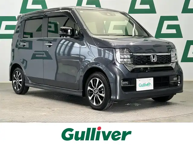 ホンダ Ｎ ＷＧＮ カスタム L 鹿児島県 2024(令6)年 0.1万km メテオロイドグレーメタリック ワンオーナー/純正ナビ/(フルセグ/BluetootAM/FM)/純正前方ドライブレコーダー/ETC/バックカメラ/前席シートヒーター/ホンダセンシング/　・衝突被害軽減ブレーキ/　・先行車発進お知らせ機能/　・歩行者事故低減ブレーキ/　・路外逸脱抑制機能/　・標識認識機能/　・オートハイビーム/　・渋滞追従機能付アダプティブクルーズコントロール/　・車線維持支援システム/　・誤発進抑制機能/電動パーキングブレーキ/オートブレーキホールド/本革巻きステアリング/ステアリングリモコン/純正アルミホイール/純正フロアマット/ドアバイザー/LEDフォグランプ