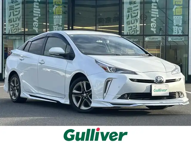 トヨタ プリウス Sツーリングセレクション 岡山県 2021(令3)年 8.4万km プラチナホワイトパールマイカ 登録時走行距離83987km/ワンオーナー/モデリスタエアロ/純正9インチSDナビ/（AM.FM.BT.フルセグ.CD/DVD）/パノラミックビューモニター/トヨタセーフティセンス/・プリクラッシュセーフティ/・アダプティブクルーズコントロール/・レーンディパーチャアラート/・オートマチックハイビーム/ビルトインETC/AC100V/合皮シート/シートヒーター/てれびきゃんせらー/スマートキー×２/純正17インチアルミホイール