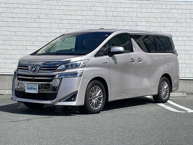 トヨタ ヴェルファイア ハイブリット V Lエディション 山形県 2018(平30)年 5.1万km スティールブロンドM 禁煙車/サンルーフ/レザーシート/Toyota Safety Sense/・プリクラッシュセーフティ/・レーントレーシングアシスト/・レーダークルーズコントロール/・ロードサインアシスト/・発進遅れ告知機能/・プロアクティブドライビングアシスト/・オートマチックハイビーム/JBLプレミアムサウンド/デジタルインナーミラー/ブラインドスポットモニター/クリアランスソナー/両側パワースライドドア/純正ナビ(CD.DVD.BT.USB.AUX)/パノラミックビューモニター/フルセグ/純正フリップダウンモニター/パワーバックドア/シートヒーター/ベンチレーション/パワーシート/ウッドコンビステアリング/電動パーキングブレーキ/オートホールド/LEDヘッドライト/プッシュスタート/スマートキー