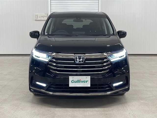 ホンダ オデッセイ ハイブリッド e:HEVアブソルート EX 熊本県 2021(令3)年 4.6万km プレミアムスパークルブラックパール 純正10インチナビ/(フルセグ/CD/DVD/Bluetooth)/(ギャザズ/VXU-217DYi)/前席パワーシート/前席シートヒーター/全方位カメラ/レーダークルーズコントロール/11.6インチフリップダウンモニター/ブラインドスポットモニター/衝突被害軽減システム/レーンキープアシスト/前後コーナーセンサー/電動パーキングブレーキ/オートブレーキホールド/LEDヘットライト＆フォグランプ/オートライト/革巻きステアリング/ステアリングスイッチ/ETC2.0/前後ドライブレコーダー/両側パワースライドドア/オットマン/スマートキー/プッシュスタート/ドアバイザー/純正フロアマット/純正18インチアルミホイール/W＋サイド＆カーテンSRS＋ABS