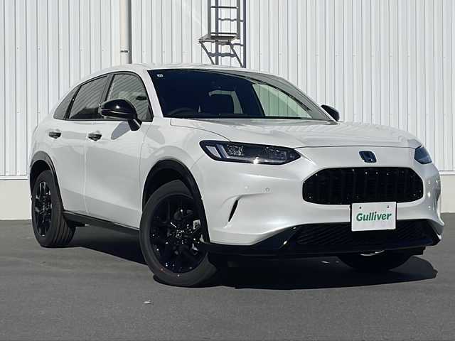 ホンダ ＺＲ－Ｖ ハイブリッド e:HEV Z ブラックスタイル 三重県 2025(令7)年 0.1千km プラチナホワイトパール 登録済未使用車/純正メーカーオプションナビ/AppleCarPlay/AndroidAuto/全周囲カメラ/ワイヤレス充電/ＢＳＭ/本革シート/全席シートヒーター/ステアリングヒーター/パワーシート/メモリーシート/追従クルーズコントロール/レーンキープアシスト/コーナーセンサー/パドルシフト/ステアリングスイッチ/電動リアゲート/スペアキー/SOSコール/先行車発進告知/標識認識システム/衝突被害軽減システム/電子パーキング/LEDライト/オートライト/オートマチックハイビーム/電動格納ミラー/禁煙車