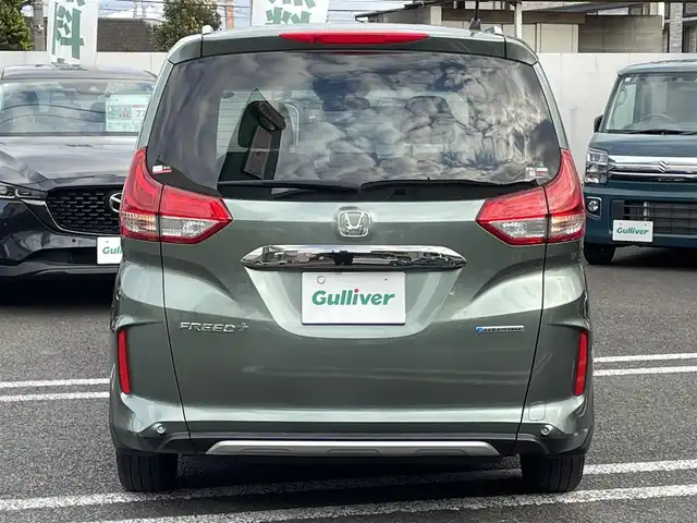 ホンダ フリード＋ ハイブリット クロスター 大分県 2023(令5)年 2.8万km シルバーミストグリーンM ワンオーナー/ハーフレザー調シート/純正メモリナビ VXM-237VFNi/【フルセグ/DVD/BTオーディオ】/バックカメラ/後席フリップダウンモニター/両側パワースライドドア/純正15インチアルミホイール/レーダークルーズコントロール/衝突被害軽減システム/レーンアシスト/ETC/LEDヘッドライト/LEDフォグランプ/オートライト/レザーステアリング/チルトステアリング/ステアリングリモコン/運転席シートリフター/前席シートヒーター/ミラーヒーター/ワイパーヒーター/ウインカーミラー/横滑り防止装置/エンジンプッシュスタート/リアプライバシーガラス/ドアバイザー/フロアマット/電動格納ミラー/カーテン＆サイド＆Wエアバッグ/ABS/スマートキー×2/保証書/車両取説/ナビ取説
