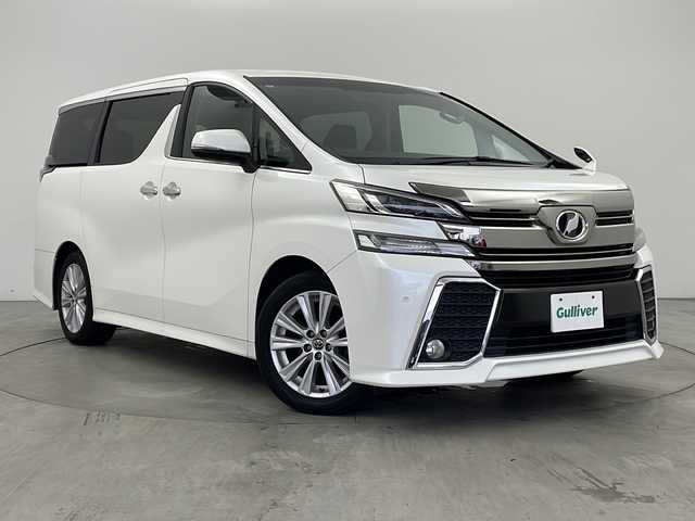 トヨタ ヴェルファイア Z Aエディション 兵庫県 2015(平27)年 8.2万km ホワイトパールクリスタルシャイン ・社外ナビ（AVN-Z04iW）/・AM/FM/CD/DVD/SD/・フルセグTV/・Bluetooth接続/・クルーズコントロール/・両側パワースライドドア/・LEDヘッドライト/・オットマン/・nanoe/・バックカメラ/・クリアランスソナー/・ビルトインETC/・LEDライト&LEDフォグ/・スマートキー/・ステアリングスイッチ/・カーテンエアバッグ/・フロアマット/・18インチアルミホイール/・スタッドレスタイヤ4本付/・取扱説明書