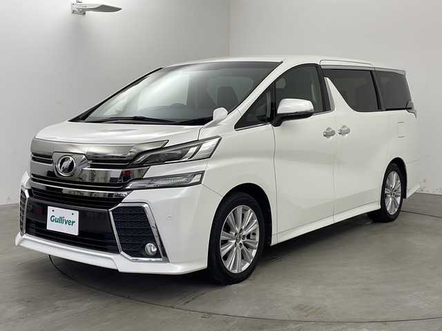 トヨタ ヴェルファイア Z Aエディション 兵庫県 2015(平27)年 8.2万km ホワイトパールクリスタルシャイン ・社外ナビ（AVN-Z04iW）/・AM/FM/CD/DVD/SD/・フルセグTV/・Bluetooth接続/・クルーズコントロール/・両側パワースライドドア/・LEDヘッドライト/・オットマン/・nanoe/・バックカメラ/・クリアランスソナー/・ビルトインETC/・LEDライト&LEDフォグ/・スマートキー/・ステアリングスイッチ/・カーテンエアバッグ/・フロアマット/・18インチアルミホイール/・スタッドレスタイヤ4本付/・取扱説明書