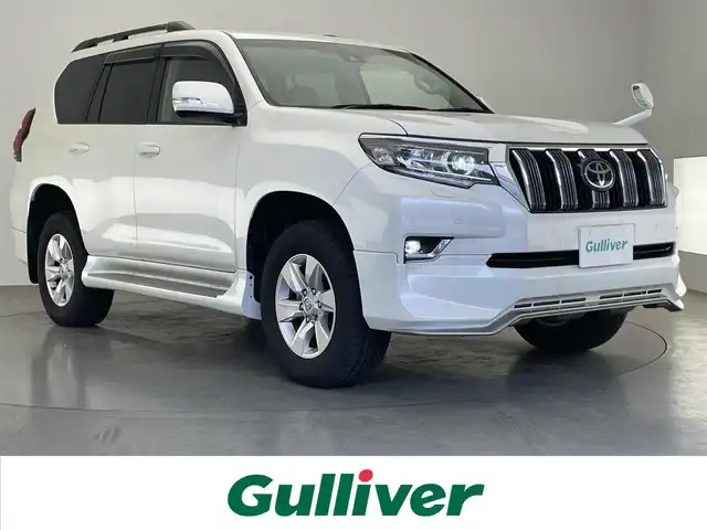 トヨタ ランドクルーザー プラド TX Lパッケージ 愛知県 2022(令4)年 1.7万km ホワイトパールクリスタルシャイン 社外９型ナビ　フルセグＴＶ　バックカメラ　ムーンルーフ　ベージュレザーシート　７人乗　純正エアロ　ブラックルーフレール　シートヒーター　エアシート　純正アルミ　サイドステップ　衝突軽減　ＬＥＤ　禁煙車