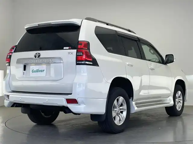 トヨタ ランドクルーザー プラド TX Lパッケージ 愛知県 2022(令4)年 1.7万km ホワイトパールクリスタルシャイン 社外９型ナビ　フルセグＴＶ　バックカメラ　ムーンルーフ　ベージュレザーシート　７人乗　純正エアロ　ブラックルーフレール　シートヒーター　エアシート　純正アルミ　サイドステップ　衝突軽減　ＬＥＤ　禁煙車