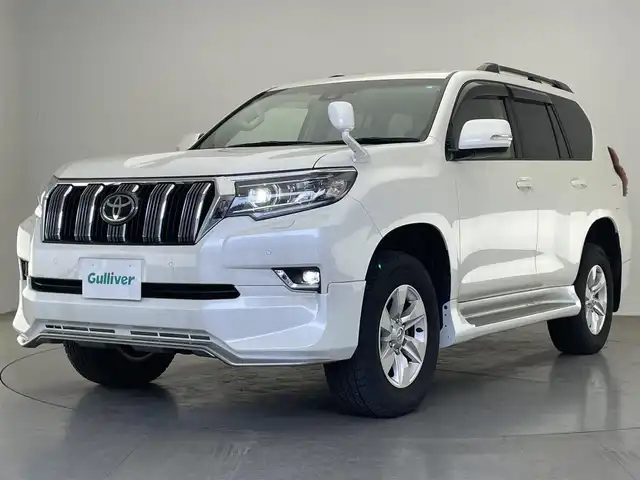 トヨタ ランドクルーザー プラド TX Lパッケージ 愛知県 2022(令4)年 1.7万km ホワイトパールクリスタルシャイン 社外９型ナビ　フルセグＴＶ　バックカメラ　ムーンルーフ　ベージュレザーシート　７人乗　純正エアロ　ブラックルーフレール　シートヒーター　エアシート　純正アルミ　サイドステップ　衝突軽減　ＬＥＤ　禁煙車