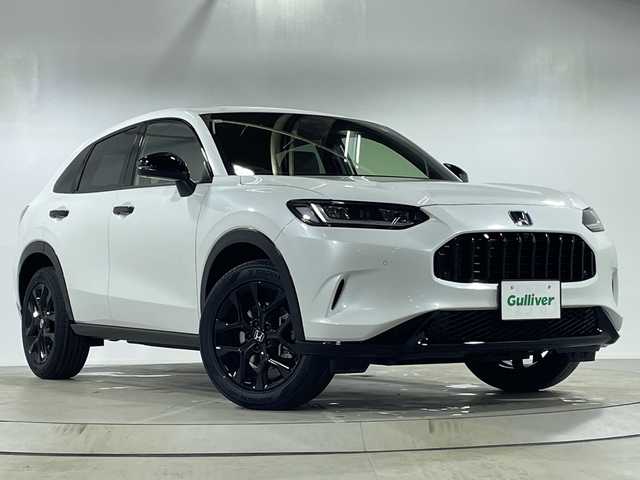 ホンダ ＺＲ－Ｖ ハイブリッド e:HEV Z ブラックスタイル 神奈川県 2025(令7)年 0.1千km プラチナホワイトパール 登録済未使用/9インチホンダコネクトディスプレー/(AM/FM/TV/Bluetooth)/マルチビューカメラシステム/デジタルインナーミラー/ブラインドスポットモニター/ホンダセンシング/衝突被害軽減システム/車線逸脱警報/アダプティブクルーズコントロール/レザーシート/横滑り防止装置/ETC2.0/アイドリングストップ/LEDヘッドライト/オートライト/ウィンカーミラー/電動格納ミラー/純正18インチAW/シートヒーター/パワーシート/ステアリングヒーター/パワーバックドア/プッシュスタート/スマートキー/スペアキー/取扱説明書/保証書