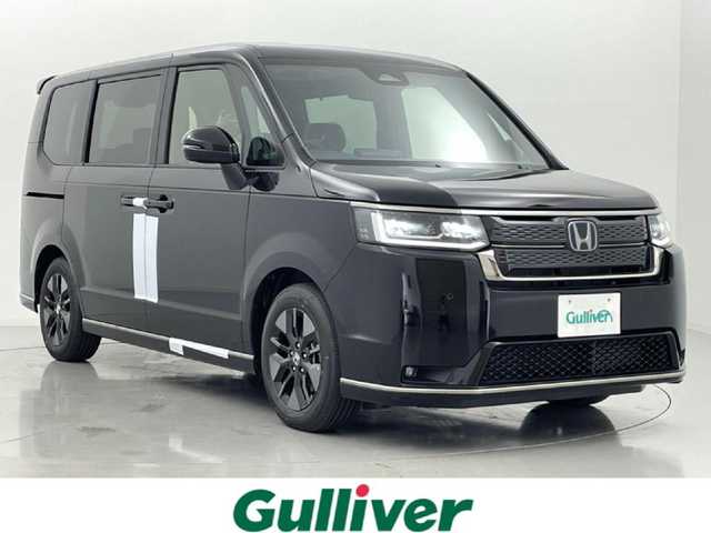 ホンダ ステップワゴン スパーダ eHEV 熊本県 2025(令7)年 0.1万km未満 クリスタルブラックパール 登録済未使用車/純正ナビ LXM-247VFLi（ＣＤ・ＤＶＤ・フルセグ・ＢＴ・ＳＤ・ＵＳＢ）/バックカメラ　/両側パワースライドドア　/前後クリアランスソナー　/前席シートヒーター　/ホンダセンシング/・衝突軽減ブレーキ/・レーンキープアシスト/・レーダークルーズコントロール/・踏み間違い防止/・標識認識機能/・後方誤発進抑制機能/・近距離衝突軽減ブレーキ/・車線維持支援システム/・歩行者事故低減ステアリング/・先行車発進お知らせ/・ブラインドスポットモニター/・路外逸脱抑制機能　/横滑り防止　/パワーバックドア/純正１６インチAW/オートライト/LEDヘッドライト/フォグライト/スマートキー/プッシュスタート/スペアキー1本