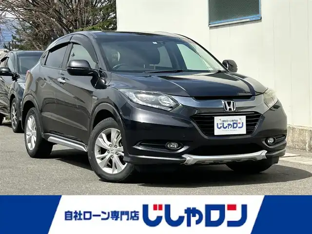 ホンダ ヴェゼル ハイブリッド X 福島県 2014(平26)年 13万km ルーセブラックM (株)IDOMが運営する【じしゃロン福島店】の自社ローン専用車両になります。こちらは現金またはオートローンご利用時の価格です。自社ローンご希望の方は別途その旨お申付け下さい/純正メモリナビ/フルセグテレビ/バックカメラ/モデューロエアロ/革巻ステアリング/クルーズコントロール/ステアリングリモコン/パドルシフト/衝突アラーム/ワイパーデアイサー/シートヒーター/ＥＴＣ
