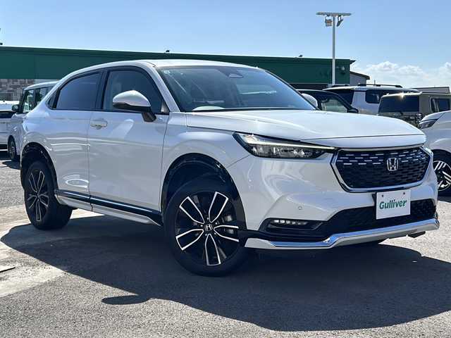 ホンダ ヴェゼル ハイブリッド e:HEV Z 徳島県 2021(令3)年 7.1万km プラチナホワイトパール 純正ナビ/（BT/フルセグ/USB/ラジオ）/バックカメラ/ETC2.0/ブラインドスポットモニター/クリアランスソナー/ワイパーデザイアー/ミラーヒーター/純正18インチアルミホイール/LEDヘッドライト/ハーフレザーシート/D/N席シートヒーター/ステアリングヒーター/追従式クルーズコントロール/電動リアゲート/前後ドライブレコーダー/純正フロアマット/寒冷地仕様/スマートキー/置くだけ充電/取扱説明書/新車時保証書
