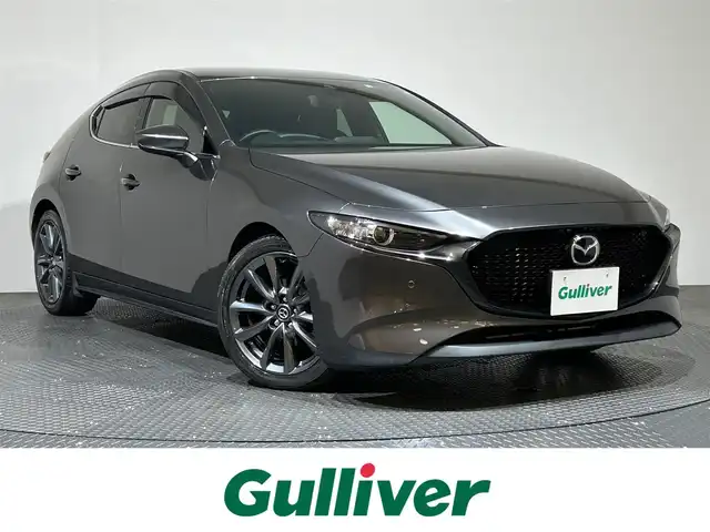 マツダ マツダ３ファストバック 15S ツーリング 愛媛県 2022(令4)年 4.5万km マシーングレープレミアムM ・８．８型ナビ/（フルセグＴＶ・ＢＴ・ＤＶＤ・ＦＭ・ＡＭ・ａｐｐｌｅ　ｃａｒｐｌａｙ・ａｎｄｒｏｉｄ　ａｕｔｏ）/・全方位カメラ　/・ＥＴＣ　/・レーダークルーズコントロール　/・衝突軽減ブレーキ　/・レーンキープ/・前後コーナーセンサー