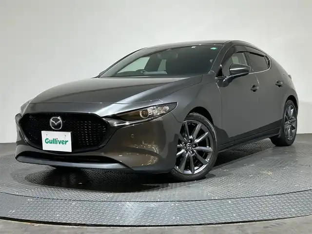 マツダ マツダ３ファストバック 15S ツーリング 愛媛県 2022(令4)年 4.5万km マシーングレープレミアムM ・８．８型ナビ/（フルセグＴＶ・ＢＴ・ＤＶＤ・ＦＭ・ＡＭ・ａｐｐｌｅ　ｃａｒｐｌａｙ・ａｎｄｒｏｉｄ　ａｕｔｏ）/・全方位カメラ　/・ＥＴＣ　/・レーダークルーズコントロール　/・衝突軽減ブレーキ　/・レーンキープ/・前後コーナーセンサー