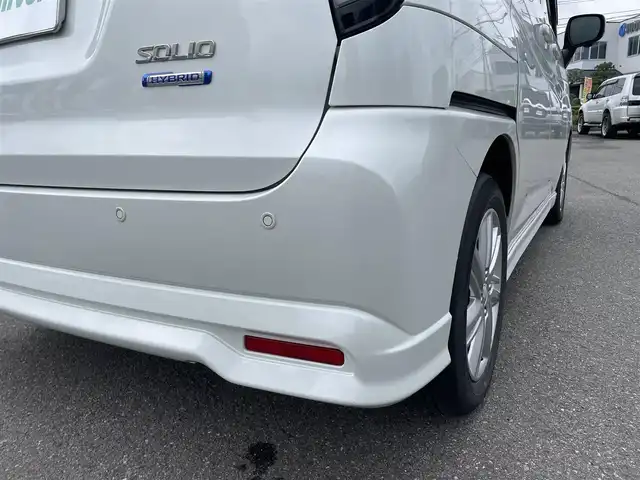 スズキ ソリオ HV MZ 山形県 2022(令4)年 4.4万km ピュアホワイトP 4WD/衝突軽減ブレーキ/両側パワースライドドア/全方位カメラ/純正10インチナビ/　【CD DVD SD USB BT】/フルセグTV/ETC/ステアリングスイッチ/レーダークルーズコントロール/アイドリングストップ/横滑り防止装置/シートヒーター/ミラーヒーター/純正アルミ/LEDライト/フォグランプ/ウィンカーミラー/純正フロアマット/ドアバイザー