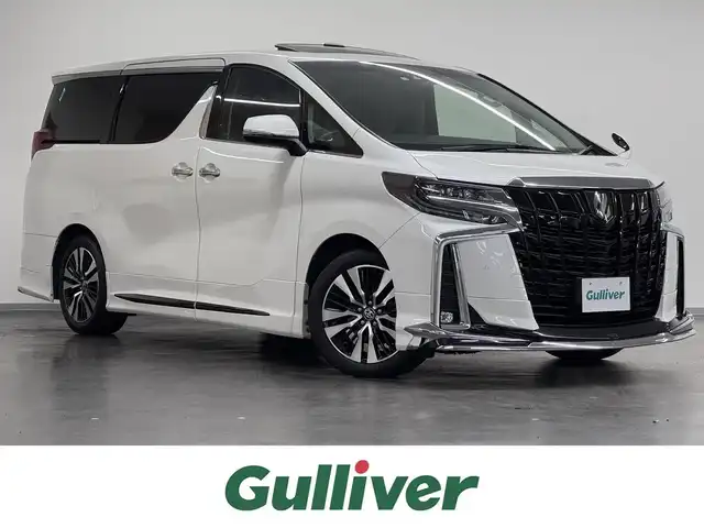 トヨタ アルファード S Cパッケージ 三重県 2020(令2)年 5.7万km ホワイトパールクリスタルシャイン ガソリン/FF/MTモード付インパネCVT/純正 9インチディスプレイオーディオ＋ナビ/（FM/AM/CD*/DVD*/USB/iPod/Bluetooth/TV/Miracast/CarPlay/AndroidAuto）/12.1インチ 後席モニター V12T-R68C/バックガイドモニター/モデリスタエアロ（F/S/R下）、スポーツマフラー/ブラックグリル（社外品?）/両側パワースライドドア/ETC/Toyota Safety Sense/・プリクラッシュセーフティ/・レーントレーシングアシスト/・クリアランスソナー/・パーキングサポートブレーキ/・アダプティブハイビームシステム/・レーダークルコン/・ロードサインアシスト/・先行車発進告知機能/・ブラインドスポットモニター＋リヤクロストラフィックアラート*/など/装備/・ツインムーンルーフ*/・デジタルインナーミラー*/・合皮シート/・パワーシート（D/N）/・エグゼクティブパワーシート（電動リクライニング＆オットマン（N/2nd））/・パワーバックドア/・シートヒーター・ベンチレーション（D/N）/・ステアリングヒーター/・オートライト/・3眼LEDヘッドランプ/・左右・後席独立オートエアコン/・純正18AW/・保/取/・スマートキーx1/など
