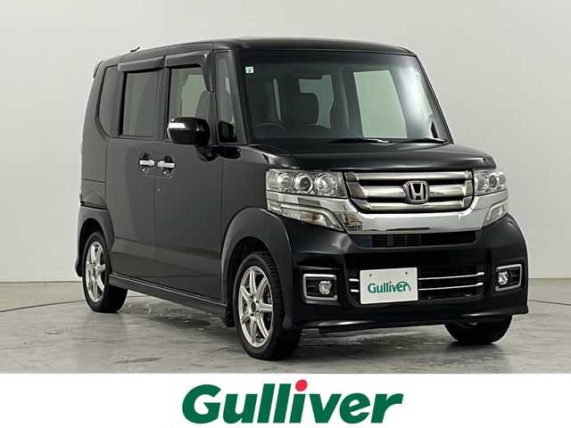 ホンダ Ｎ ＢＯＸ カスタム G ターボ Lパッケージ 道央・札幌 2015(平27)年 8.1万km スマートブラック ・4WD / ターボ/・純正8インチナビゲーション/（型番：VXM-155VFEi）/【CD/DVD/SD/BT/TV】/・バックカメラ/・社外フリップダウンモニター/・クルーズコントロール/・本革巻ステアリング/パドルシフト/・ステアリングスイッチ/・両側パワースライドドア/・前席シートヒーター/・HIDオートライト/・シートバックテーブル/・リアドアサンシェード/・VSA（ABS＋TCS＋横すべり抑制）/・ドアバイザー
