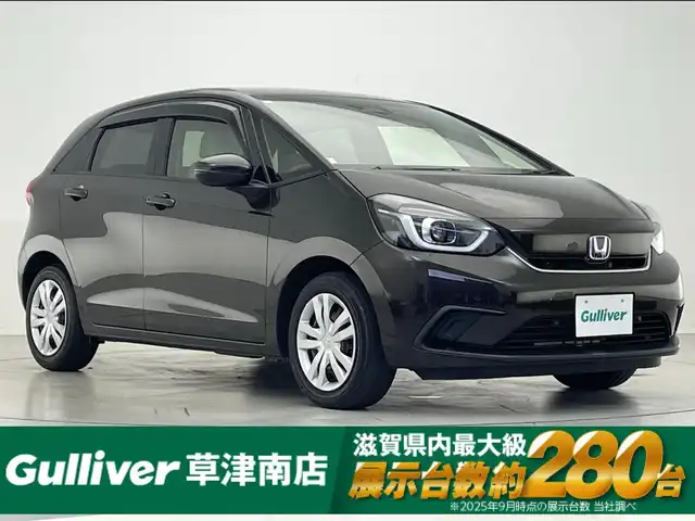 ホンダ フィット e:HEVホーム 滋賀県 2020(令2)年 7万km プレミアムグラマラスブロンズP 純正9インチナビ/【Bluetooth/CD/DVD/フルセグTV/USB】/ハーフレザーシート/ホンダセンシング/・衝突軽減ブレーキ/・誤発進抑制機能/・後方誤発進抑制機能/・近距離衝突軽減ブレーキ/・歩行者事故低減ステアリング/・路外逸脱抑制機能/・渋滞追従機能付アダプティブクルーズコントロール/・車線維持支援システム/・先行車発進お知らせ機能/・標識認識機能/・オートハイビーム/バックカメラ/クリアランスソナー/LEDヘッドライト/ビルトインETC/前方ドライブレコーダー/電動パーキングブレーキ/オートブレーキホールド/純正フロアマット/ドアバイザー/プッシュスタート/スマートキー/ステアリングリモコン