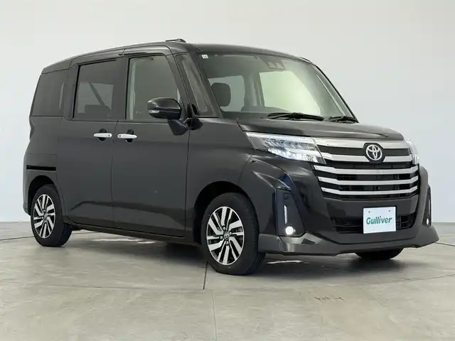 トヨタ ルーミー カスタムG 愛知県 2023(令5)年 2.1万km ブラックマイカメタリック スマートアシスト/純正9インチナビ/（Bluetooth/CD/DVD/AM/FM）/全方位カメラ/アダプティブクルーズコントロール/ETC/両側パワーバックドア/シートヒーター/オートライト/純正LEDライト/純正AW/電動格納ミラー/後席テーブル/電子パーキング/オートホールド/テレビキャンセラー/プッシュスタート/スマートキー