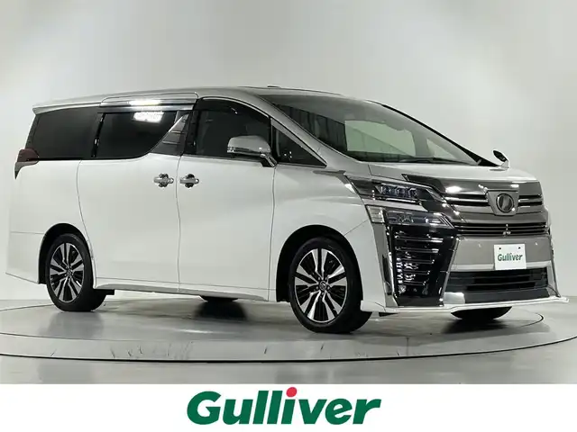 トヨタ ヴェルファイア Z Gエディション 佐賀県 2019(平31)年 1.6万km ホワイトパールクリスタルシャイン 社外アルパイン製11インチナビ（EX11Z）/（フルセグTV.CD.DVD.Bluetooth）/サンルーフ/3眼LEDヘッドライト/衝突被害軽減システム/レーダークルーズコントロール/クリアランスソナー/ロードサインアシスト/パーキングサポートブレーキ/レーンアシスト/オートマチックハイビーム/オートライト/前後ドライブレコーダー/シーケンシャルウィンカー/ビルトインETC/両側パワースライドドア/ステアリングヒーター/メモリーシート/運転席・助手席シートヒーター/運転席・助手席エアシート/合皮シート/オートワイパー/後席サンシェード/純正フロアマット/純正18インチアルミホイール