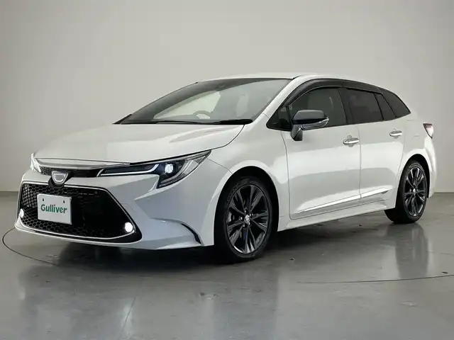 トヨタ カローラツーリング ハイブリッド ダブルバイビー 愛知県 2020(令2)年 5.8万km ホワイトパールクリスタルシャイン 純正９型ＤＡナビフルセグＴＶ　シートヒーター　ＤＶＤデッキ　革調シートカバー　モデリスタガーニッシュ多数　電動パーキング　ＨＵＤ　前後ドラレコ　セーフティセンス　衝突軽減　追従クルコン　ＬＥＤライト　禁煙車　純正フロアマット　ドアバイザー　コーナーセンサー　ステアリングヒーター　トノカバー