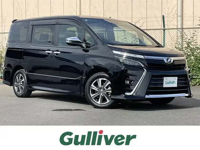 トヨタ ヴォクシー ZS 煌 東京都 2018(平30)年 1.8万km ブラック 純正９型ナビ　/・Ｂｌｕｅｔｏｏｔｈ　/・フルセグ　/・ＣＤ／ＤＶＤ再生　/純正１２型フリップダウンモニター　/ＴＳＳ　/・クルーズコントロール　/・衝突軽減/・LKAS　/両側電動スライドドア　/バックモニター　/ＡＨＢ　/ＬＥＤヘッド